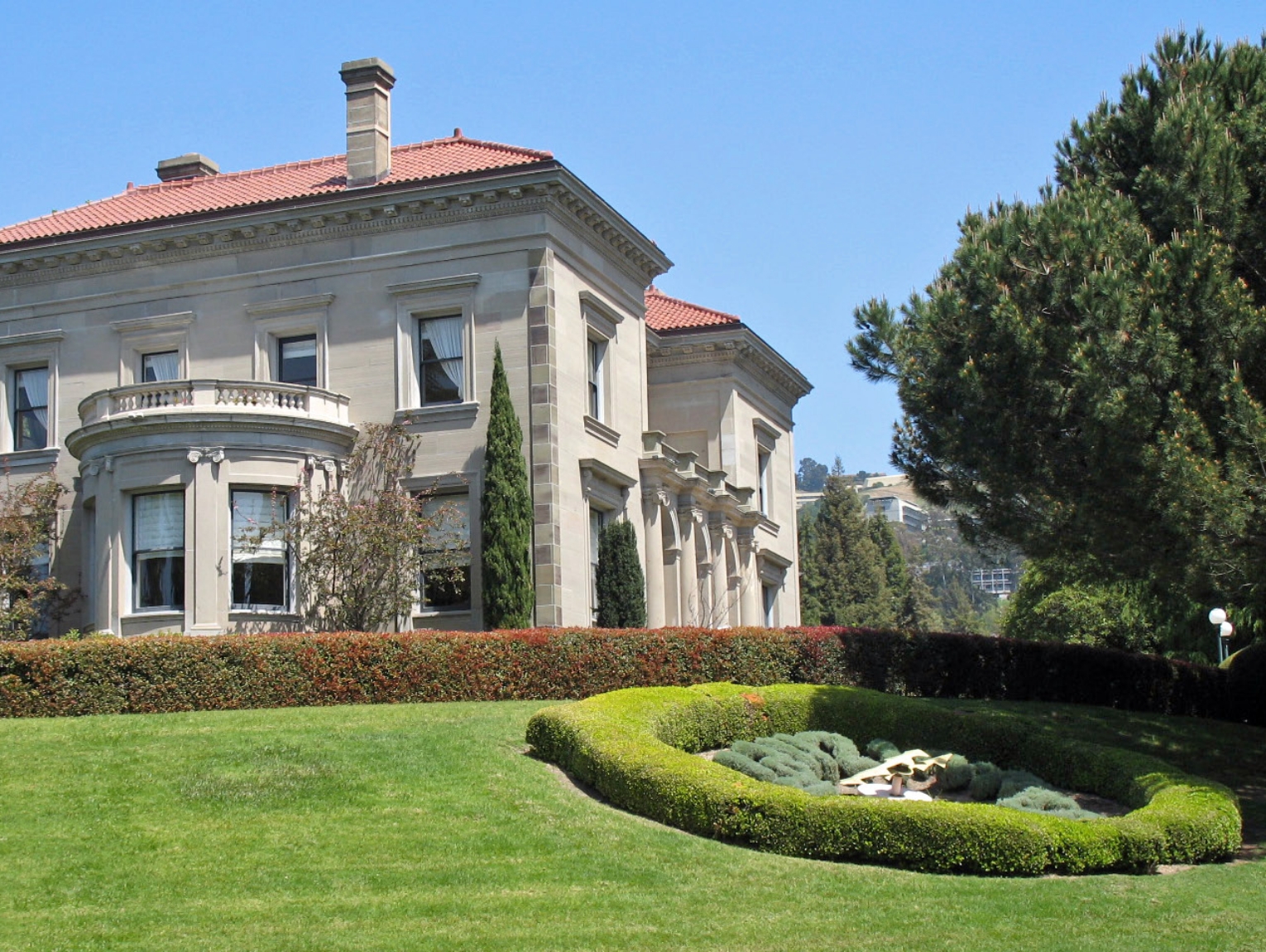 A university campus building framed by manicured lawns and trees