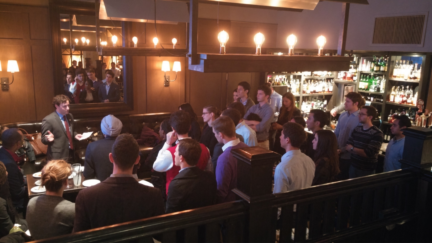Students gathered at a tavern table for a post-tour meet in Cambridge